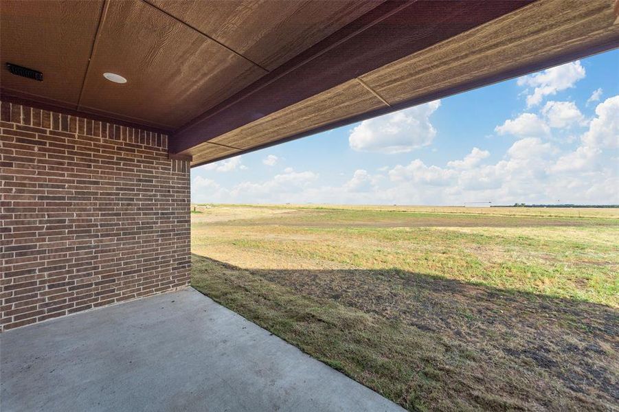 View of yard with a patio area and a rural view