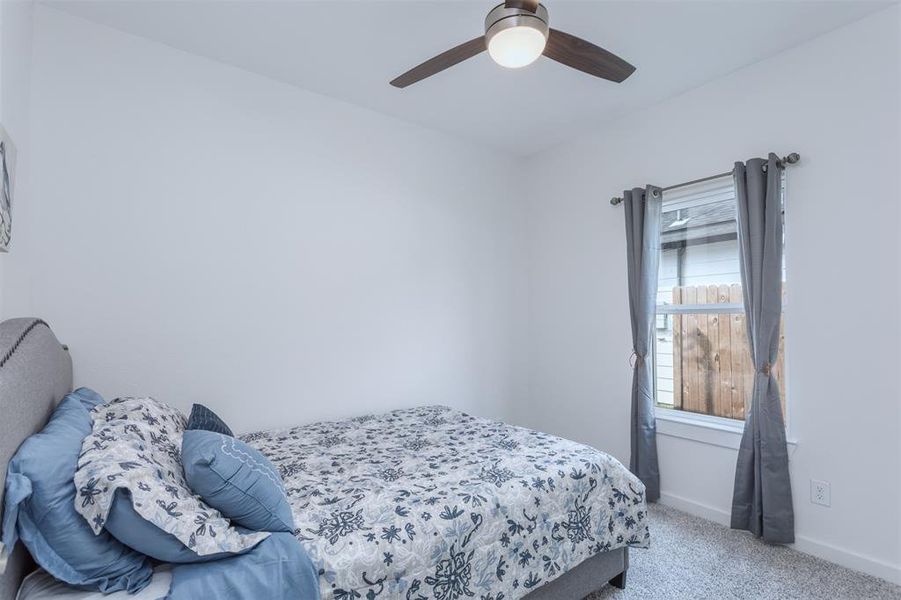 Bedroom featuring light carpet and ceiling fan