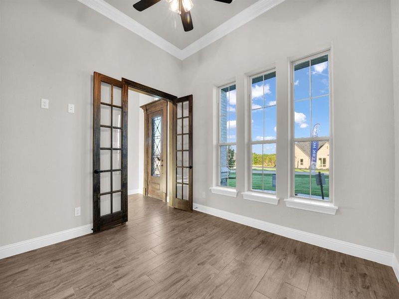 Unfurnished room featuring french doors, ornamental molding, ceiling fan, and hardwood / wood-style floors