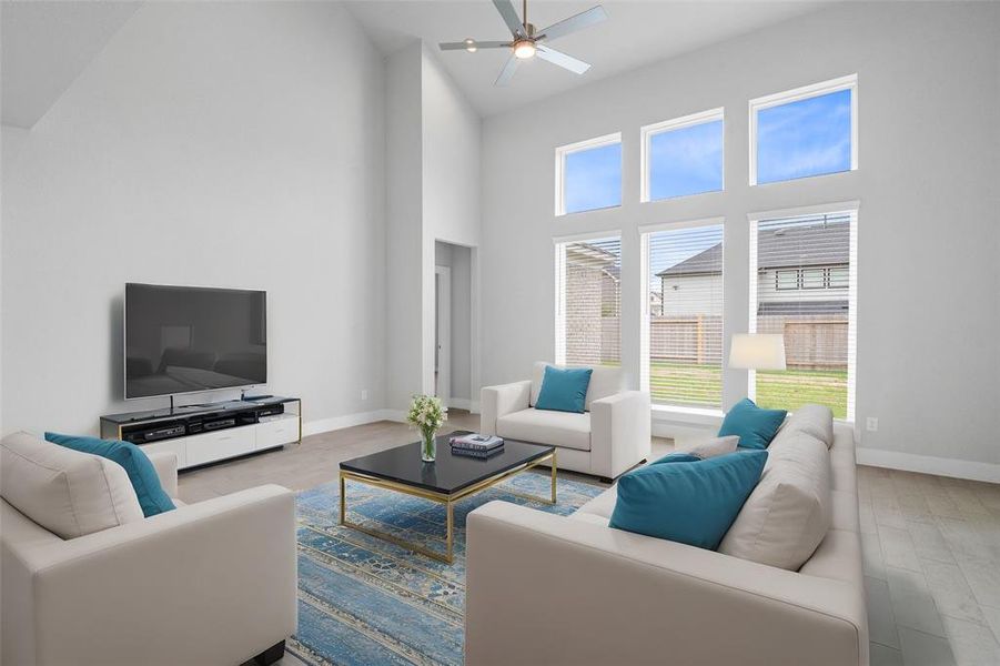 Gather the family and guests together in your lovely family room! Featuring high ceilings, recessed lighting, ceiling fan, custom paint, gorgeous floors and large windows that provide plenty of natural lighting throughout the day.