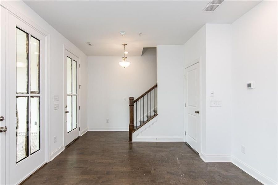 Entryway with dark hardwood / wood-style floors with the door leading to a 2 car garage , not the actual unit