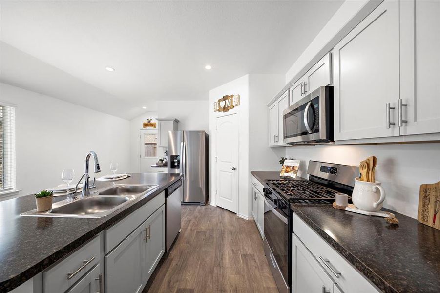 With Granite countertops, stainless steel appliances, and plenty of storage space, this kitchen has it all.