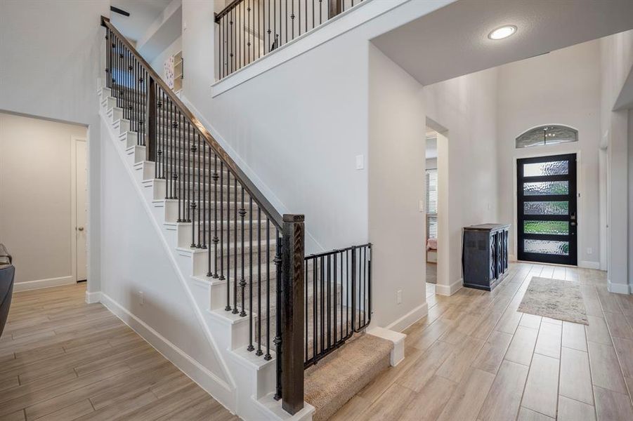 Another view of the entry way and stairs! Towards the front of the home you'll find the home office and downstairs secondary bedroom with full bathroom! Heading upstairs, there's the game room, media, and additional bedrooms.