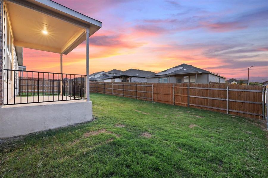 Enjoy gentle breezes on the covered patio overlooking the fenced back yard.