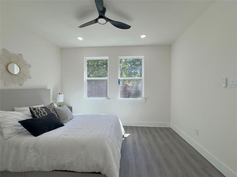 Bedroom featuring wood-type flooring and ceiling fan