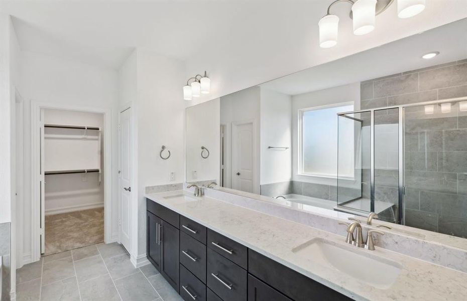 Elegant owner's bath with dual vanity *real home pictured