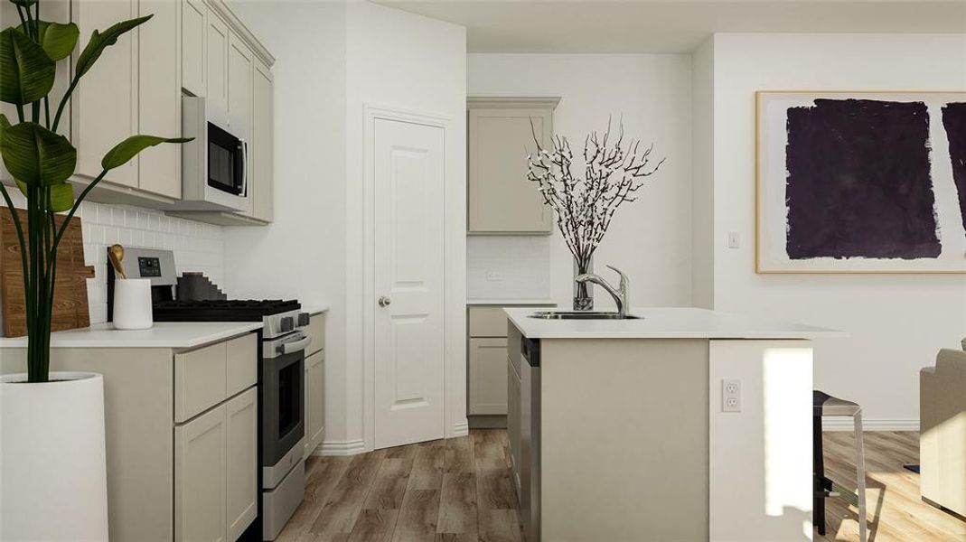 Kitchen featuring appliances with stainless steel finishes, a kitchen island with sink, wood-type flooring, sink, and tasteful backsplash