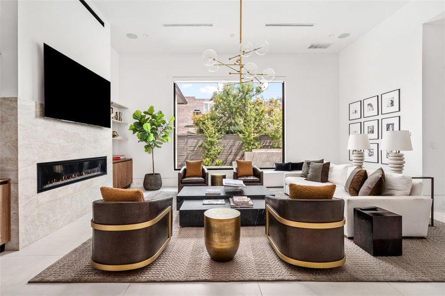 Back inside, the open, airy layout of this incredible family room is enhanced by an expansive steel framed window that floods the space with natural light and overlooks the sparkling pool for added relaxation.