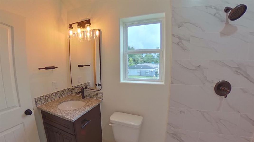 4209 Tampico St.Master Bathroom is brightened by the Edison light fixture.