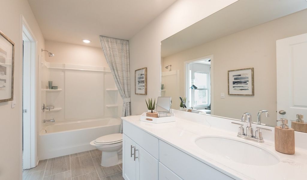 A jack-and-jill style bathroom connects the two secondary bedrooms.