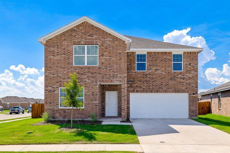 View of property featuring a front yard and a garage