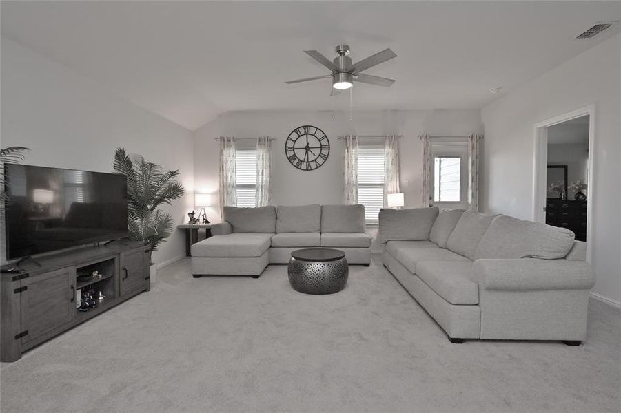 Spacious living area with a back wall of windows