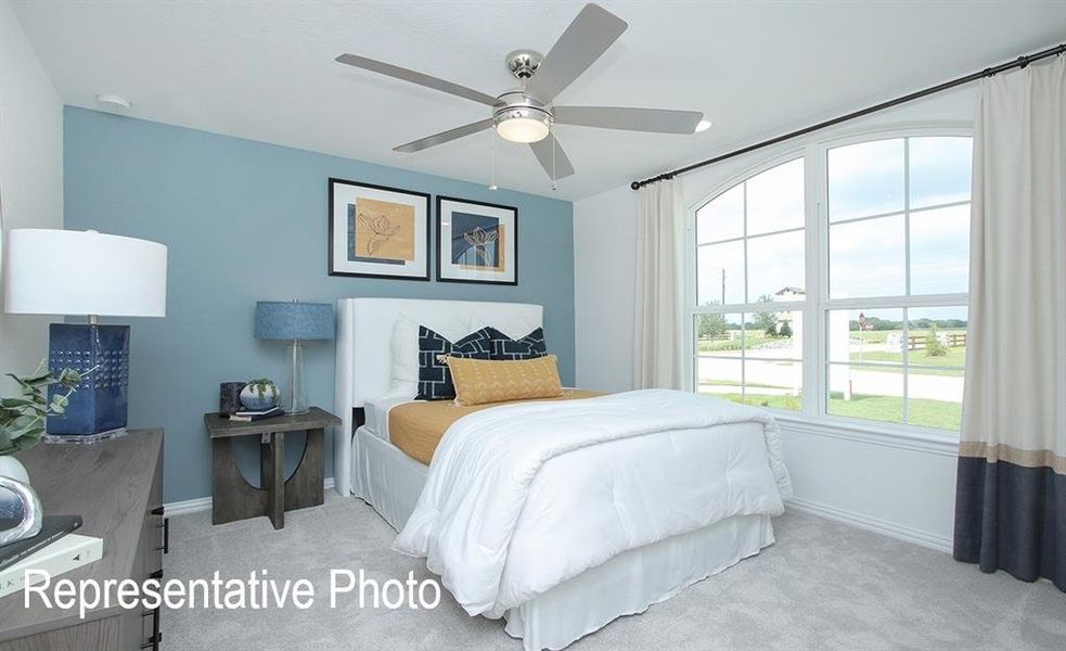 Bedroom with ceiling fan and light carpet