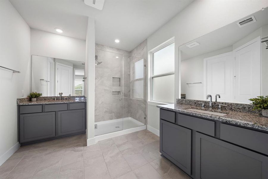 Primary bath features two sink areas and walk-in shower.