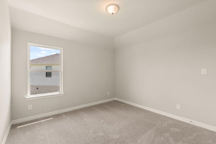 Your secondary bedroom features plush carpet, fresh paint, closet, and a large window that lets in plenty of natural lighting.