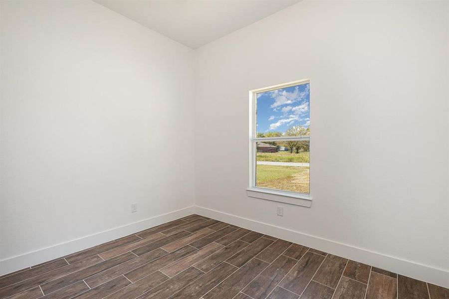 Spare room featuring dark hardwood / wood-style floors