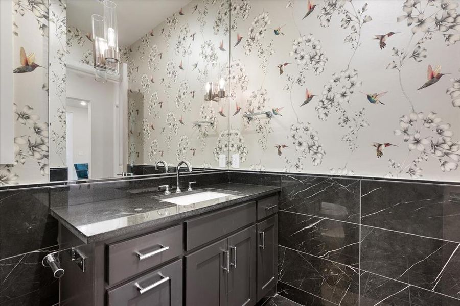 Bathroom with tile walls and vanity