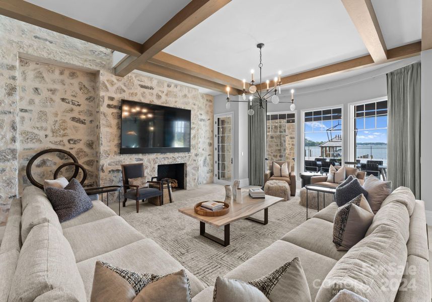 The lake-level family room looks out to the pool, lake, and green space.