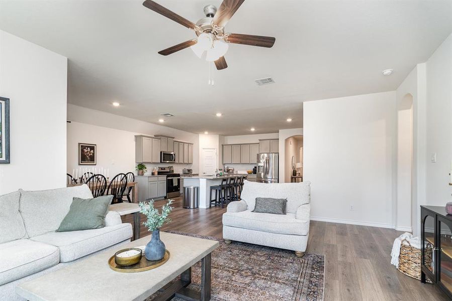 Living room featuring dark hardwood / wood-style floors and ceiling fan