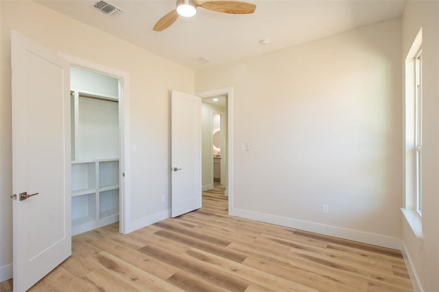 Unfurnished bedroom with a closet, ceiling fan, and light hardwood / wood-style floors