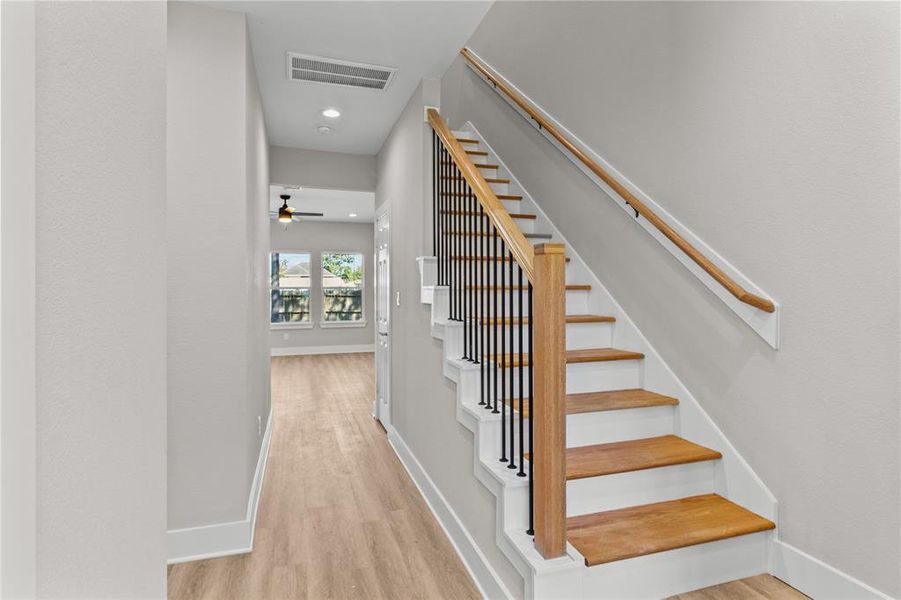 Welcome home! The inviting entryway features a staircase to the right and a hallway leading to the spacious living room and kitchen. Plus, a convenient coat closet is tucked away (not pictured).