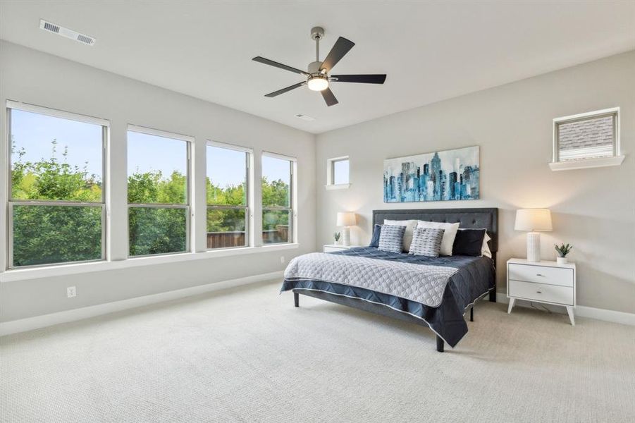 Bedroom featuring ceiling fan and carpet floors