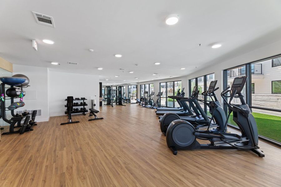 Fitness studio with free weights, cardio equipment, and more