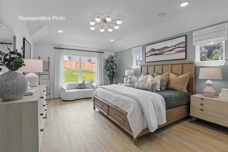 Bedroom with light hardwood / wood-style flooring and a chandelier