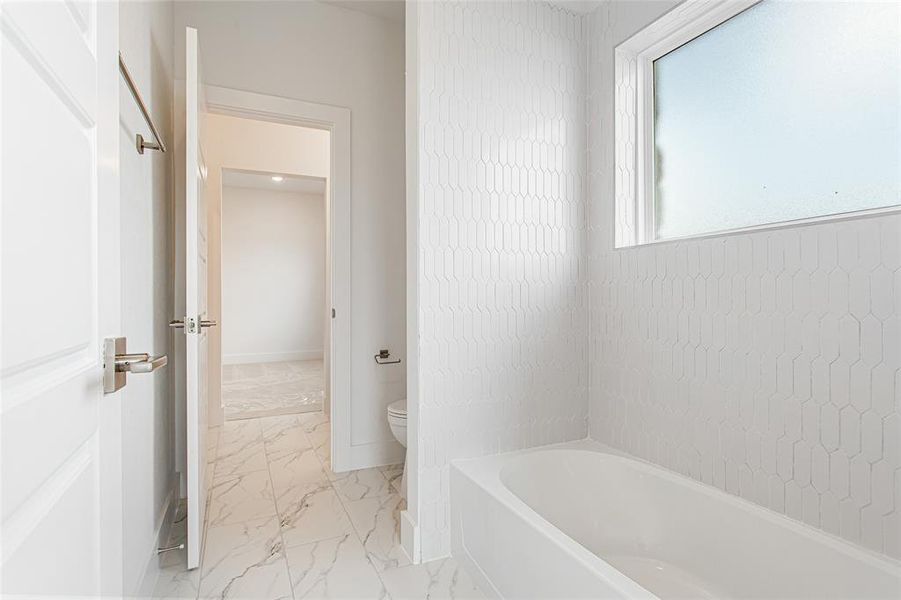 Bathroom with tile patterned flooring and toilet
