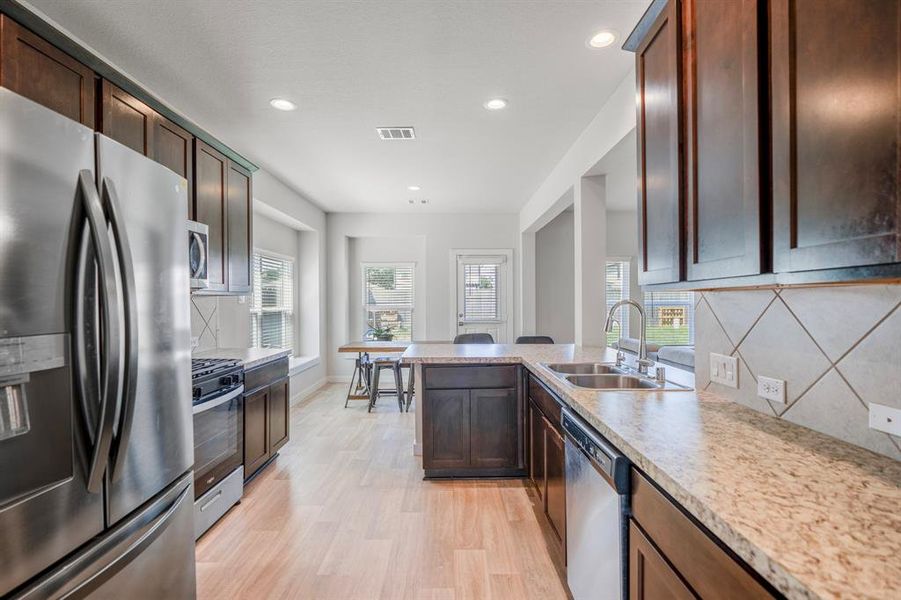 This kitchen conveniently connects to the breakfast area and living room for easy entertaining! It is perfect for everyday life as well as entertaining family and friends!