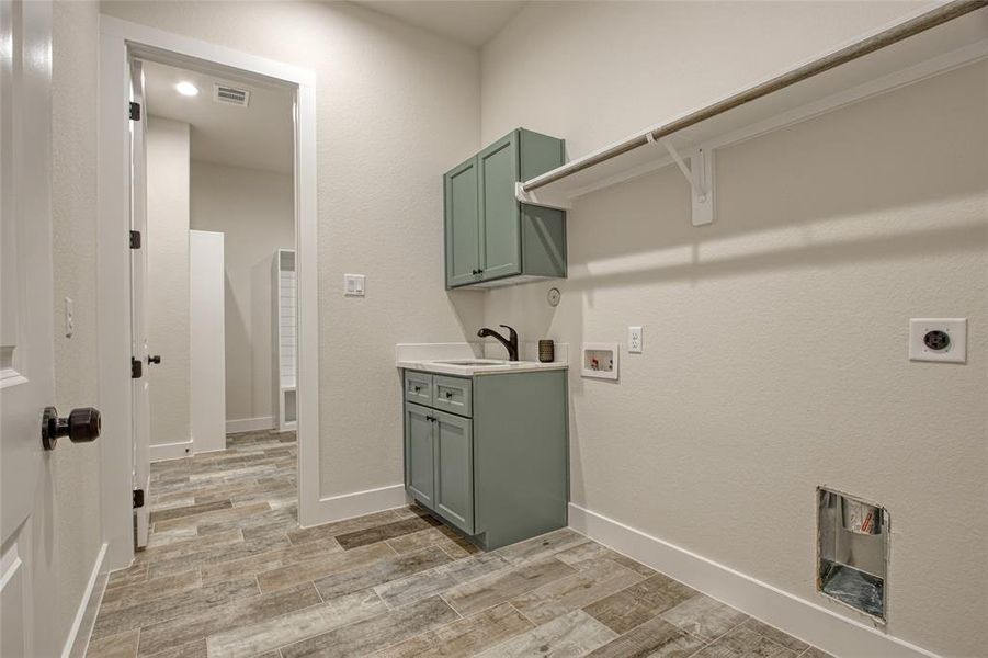 Extra large laundry with cabinets and sink