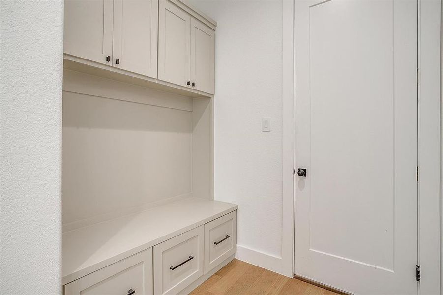 Mudroom with light hardwood / wood-style flooring