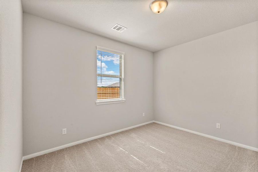 Your secondary bedroom features plush carpet, fresh paint, closet, and a large window that lets in plenty of natural lighting.