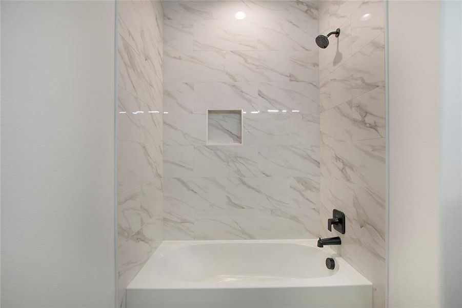 Bathroom featuring tiled shower / bath combo