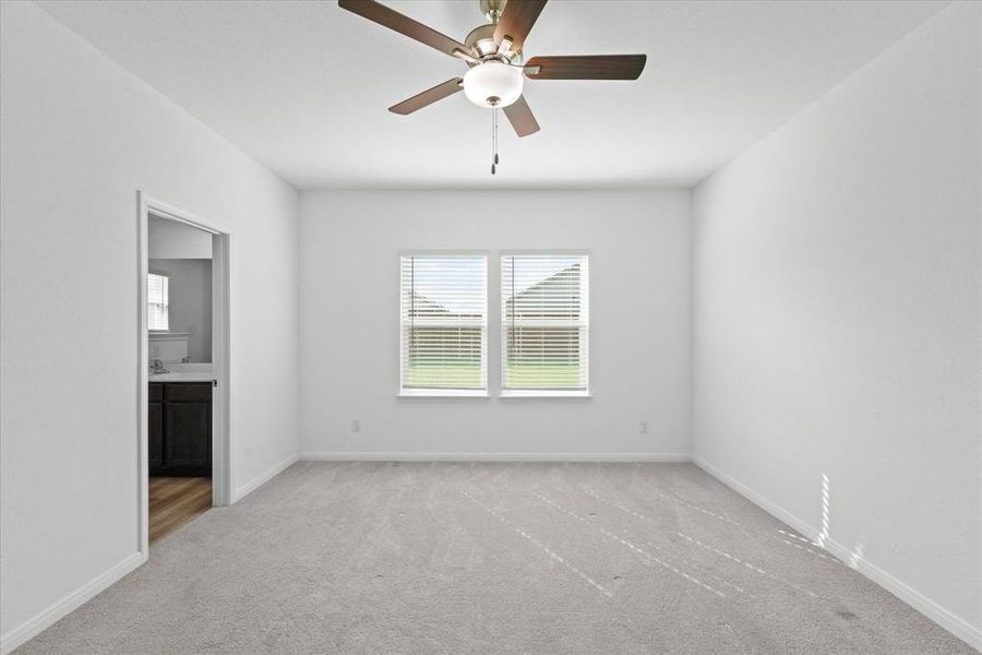 Spare room with carpet flooring and ceiling fan