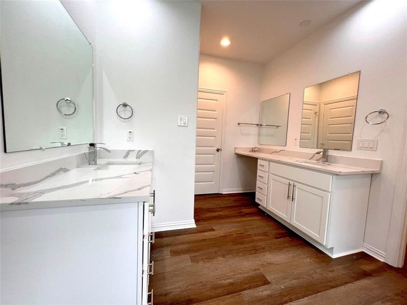 Master Bathroom featuring hardwood / wood-style flooring, oversized vanity and sinks for her and him
