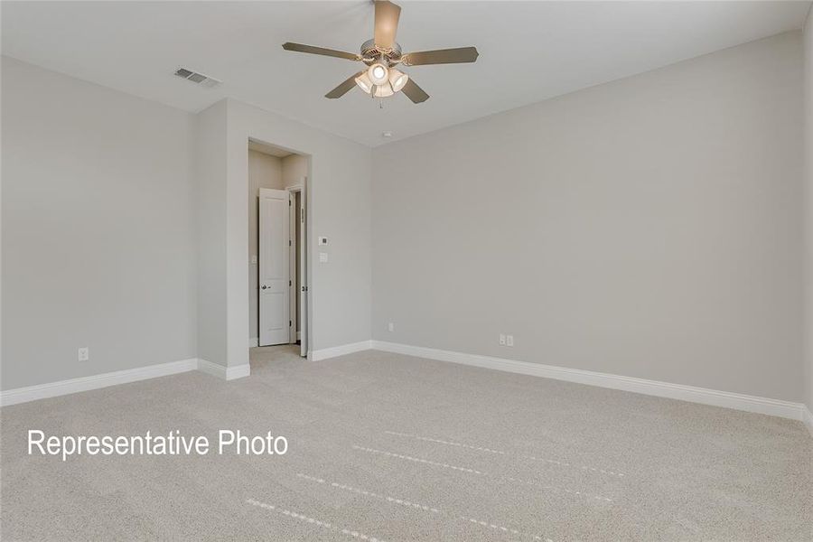 Unfurnished room with ceiling fan and light carpet