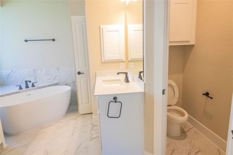 Bathroom with vanity, tile patterned flooring, and toilet