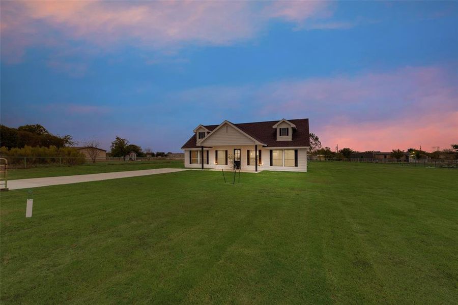 View of front of property with a yard