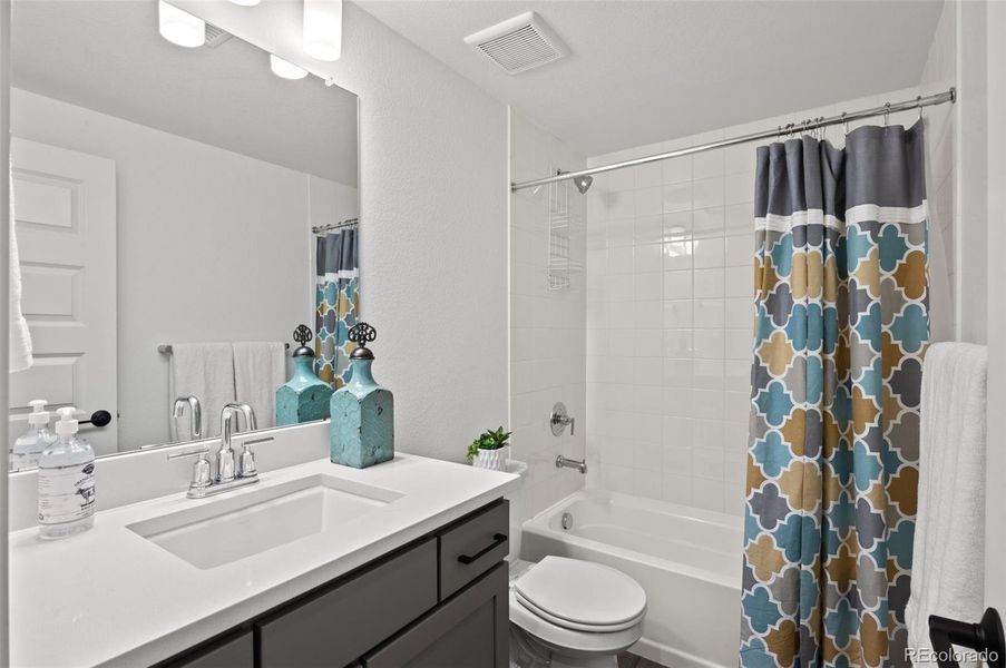 Basement-Level Full Bathroom: Tub/Shower~ Vanity~ Toilet