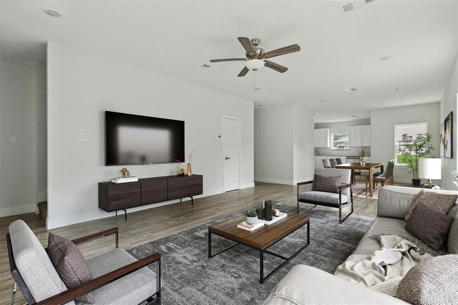 Living room with ceiling fan and dark hardwood / wood-style floors