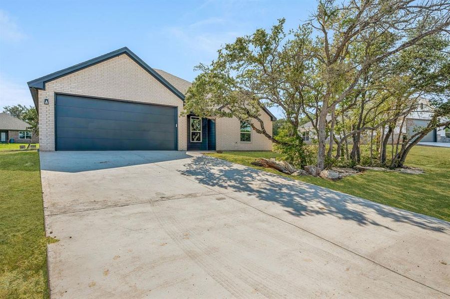 View of front of property with a front lawn and a garage