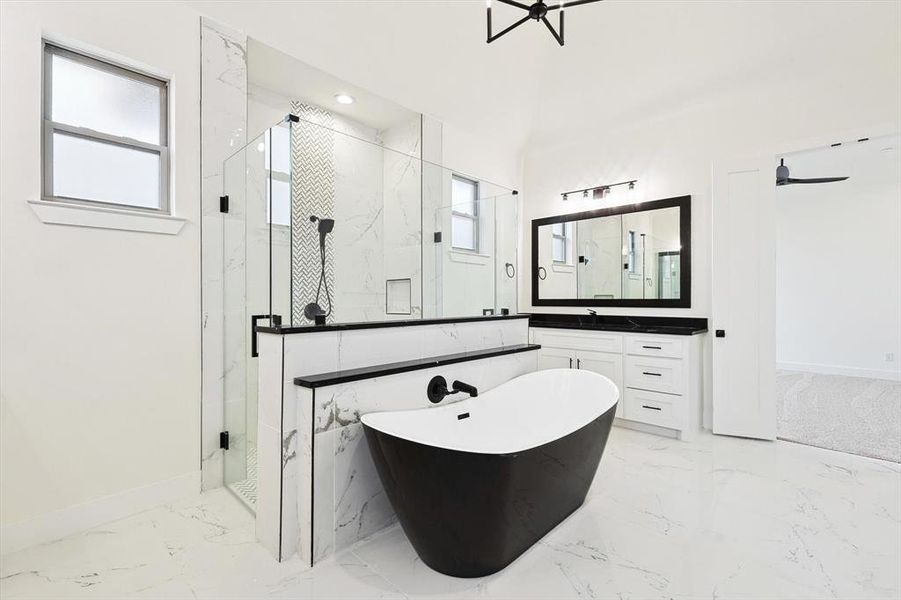 Bathroom featuring vanity, plus walk in shower, and a wealth of natural light