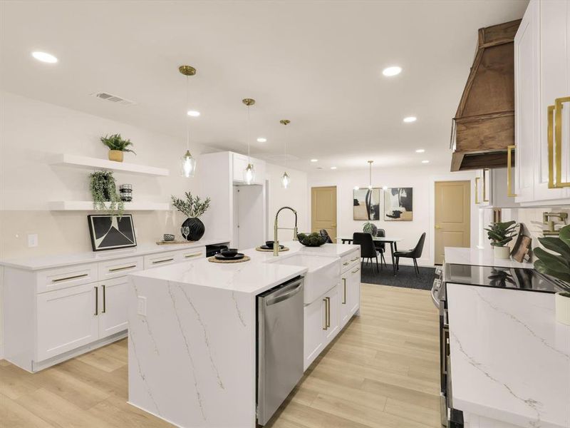 Kitchen featuring white cabinets, hanging light fixtures, dishwasher, and a center island with sink