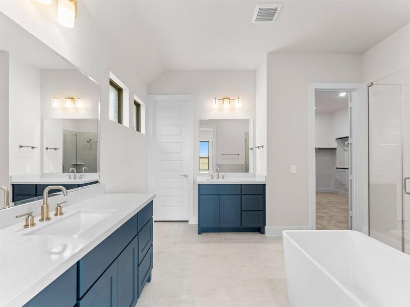 Primary Bath with Separate Vanities, Freestanding Tub, Separate Shower, and Enclosed Toilet.