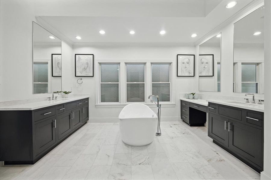 Luxurious marble bathroom with dual sinks, vanity and soaking tub