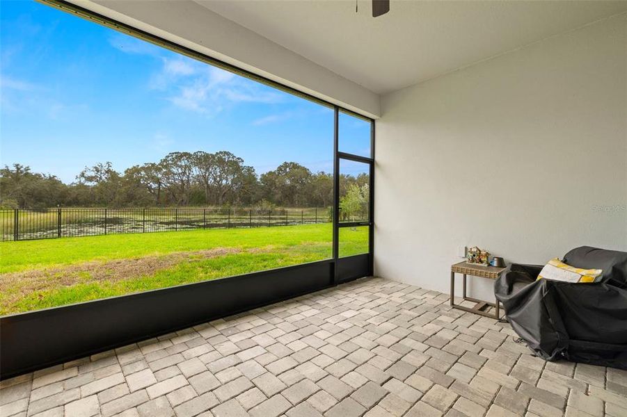 Enjoy drinking Your Coffee or Cocktails at the Covered/Screened Lanai with Pavers & Ceiling Fan Overlooking the Relaxing Pond Views