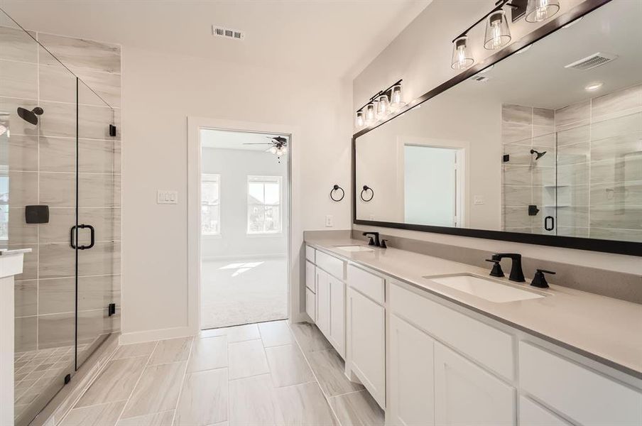 Bathroom with a shower with door, vanity, and ceiling fan