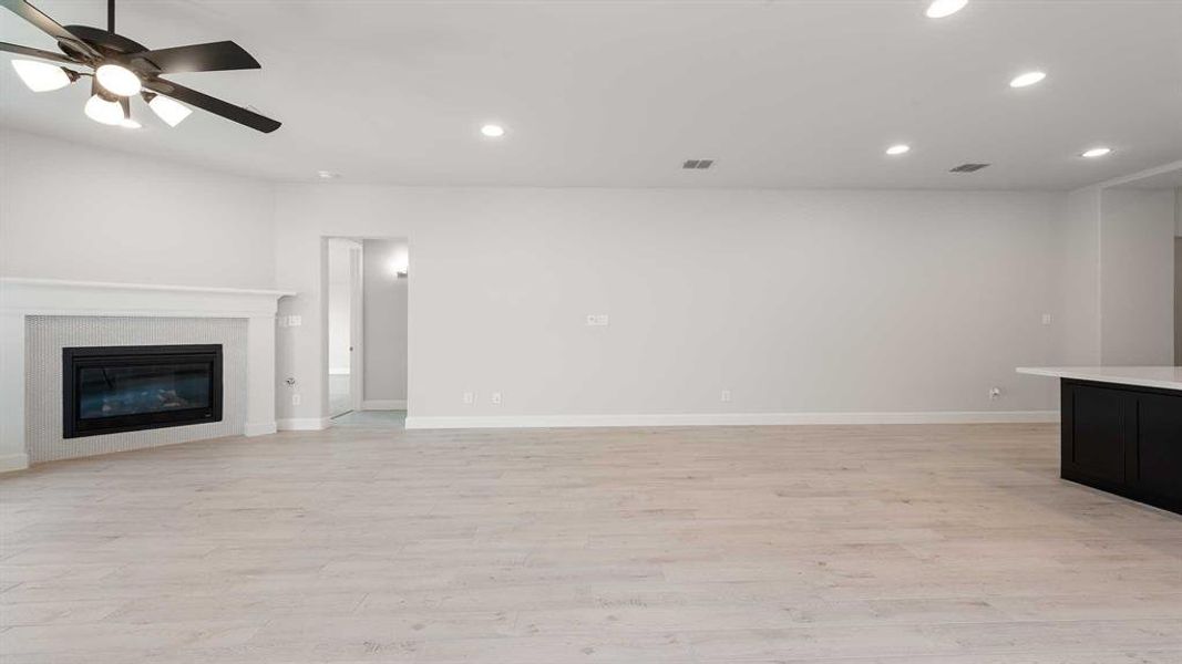 Unfurnished living room featuring light hardwood / wood-style floors and ceiling fan