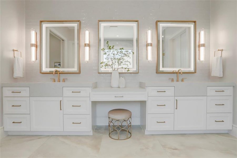 The Primary Bathroom also features Quartz countertops, double vanity, large LED mirrors, brass and glass sconces, a make-up vanity and a tile accent wall.